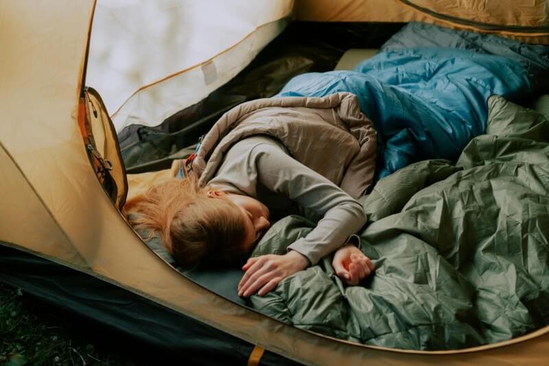 Woman Sleeping Inside a Tent